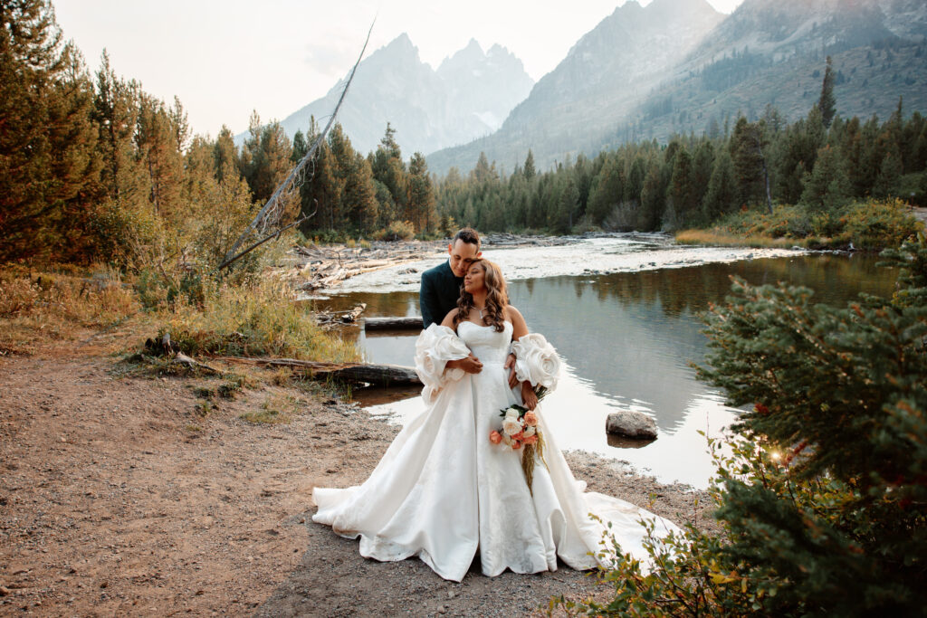 A newlywed couple at a lake at their Jackson Hole Elopement 