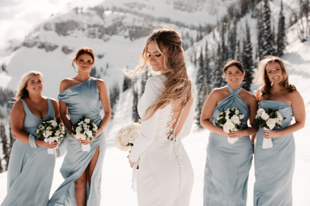 A bride and bridesmaids at a winter wedding at the Rendezvous Lodge