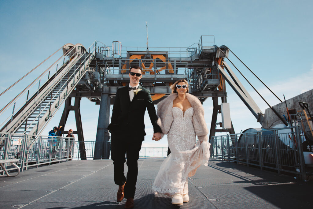 A bride and groom step off the aerial tram for a winter ceremony at Jackson Hole Mountain Resort