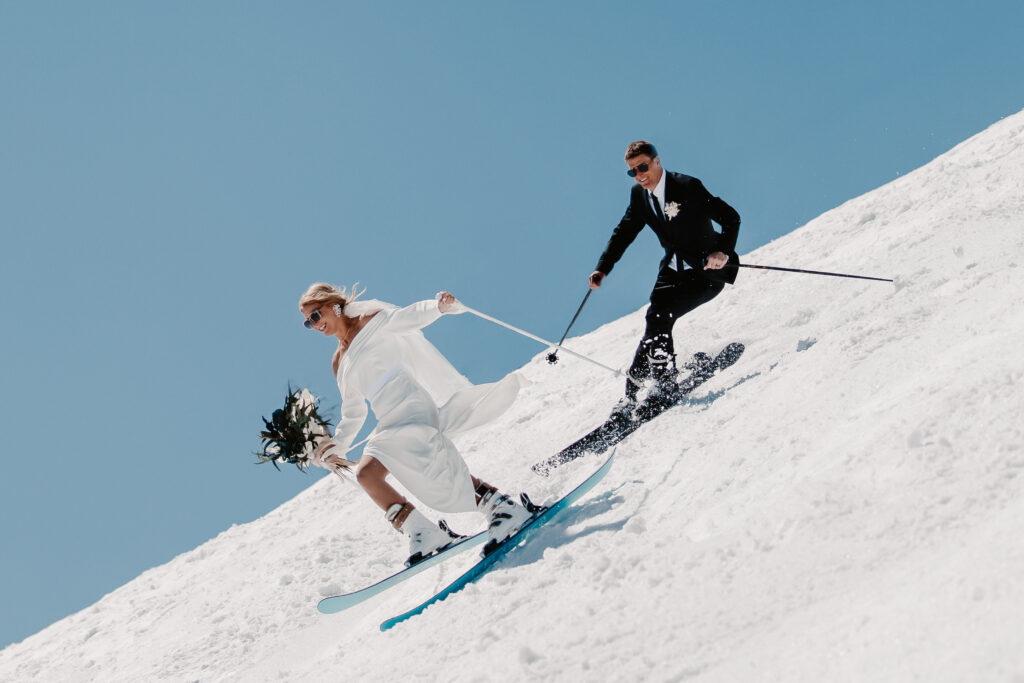 A bride and groom skiing after their Jackson Hole Mountain Resort wedding.