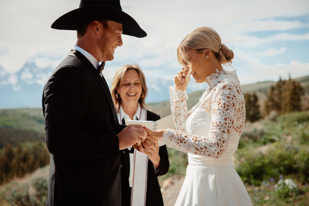 A bride and groom exchange rings during their intimate ceremony at the Wedding Tree in Jackson Hole